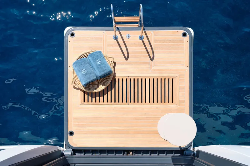  Yacht Photos Pics Luxury yacht Lagoon Seventy 7 swim platform with towels, ladder, and ocean view, 2023 model.