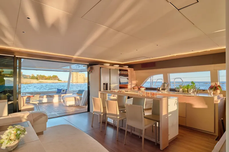  Yacht Photos Pics Luxurious interior of 2023 Lagoon Seventy 7 yacht with ocean view and modern kitchen.