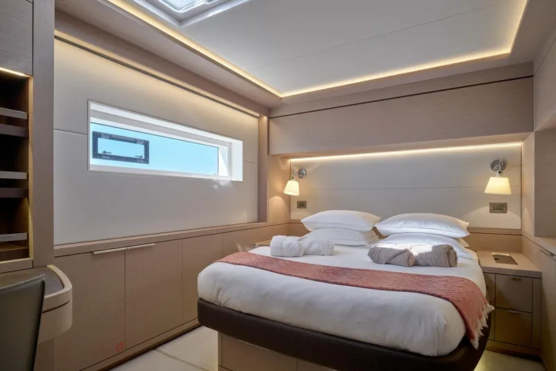  Yacht Photos Pics Luxurious 2023 Lagoon Seventy 7 yacht bedroom with modern design and ambient lighting.