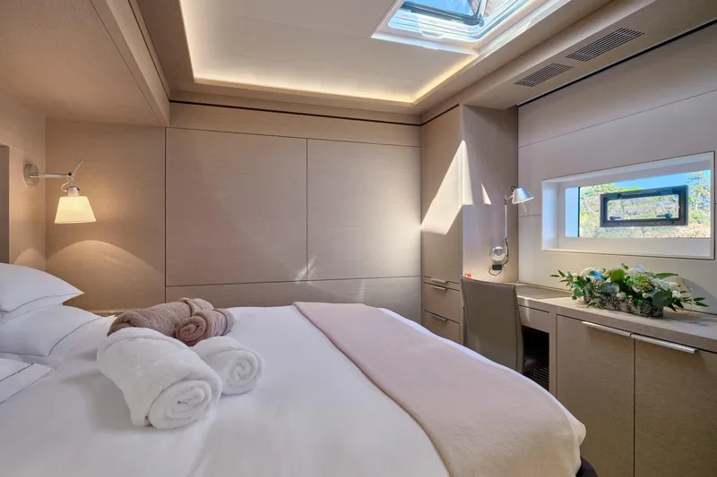  Yacht Photos Pics Luxurious bedroom interior of 2023 Lagoon Seventy 7 yacht with elegant decor and natural light.