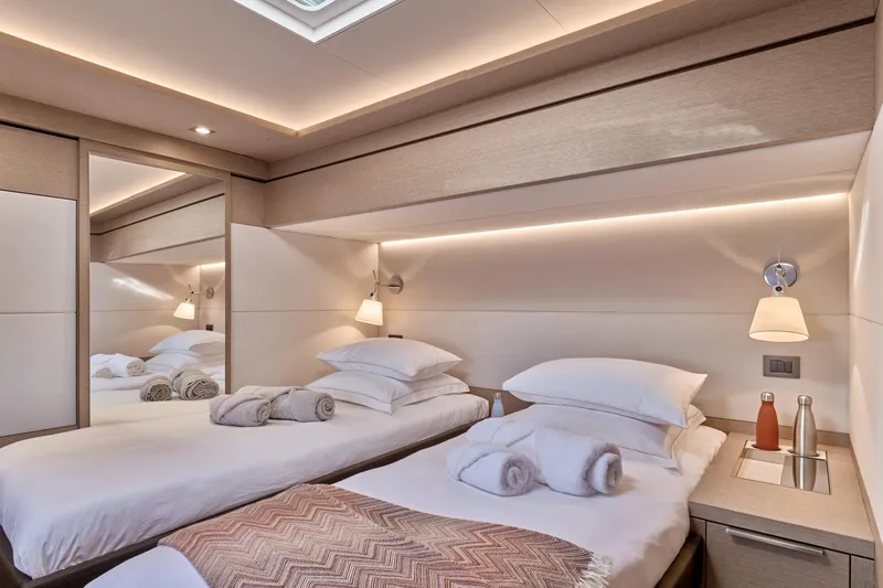  Yacht Photos Pics Luxurious 2023 Lagoon Seventy 7 yacht cabin with twin beds and elegant lighting.