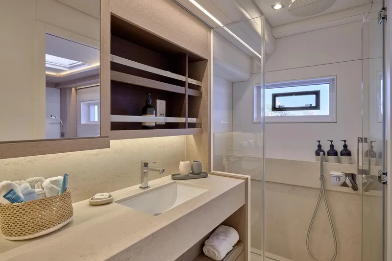  Yacht Photos Pics Luxurious bathroom interior of 2023 Lagoon Seventy 7 yacht with modern fixtures and elegant design.