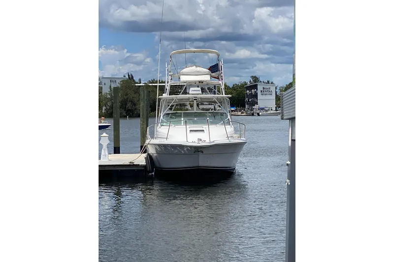  Yacht Photos Pics 2005 Stamas 370 Express docked at marina under cloudy sky.