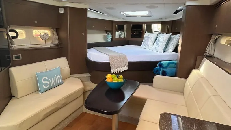 Andiamo Yacht Photos Pics Luxurious interior of 2016 Sea Ray 350 Sundancer yacht with cozy seating and elegant decor.