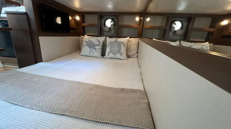 Andiamo Yacht Photos Pics Interior cabin of 2016 Sea Ray 350 Sundancer with cozy bedding and decorative pillows.