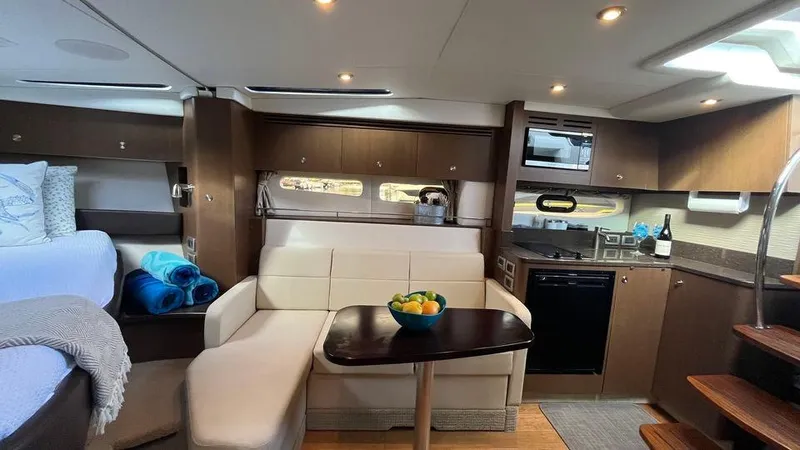 Andiamo Yacht Photos Pics Luxurious interior of 2016 Sea Ray 350 Sundancer yacht with modern kitchen and seating area.