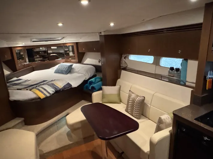 Andiamo Yacht Photos Pics Luxurious interior of 2016 Sea Ray 350 Sundancer yacht with cozy seating and bed.
