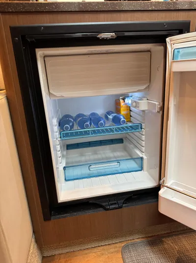 Andiamo Yacht Photos Pics Mini fridge inside 2016 Sea Ray 350 Sundancer, stocked with drinks and snacks.