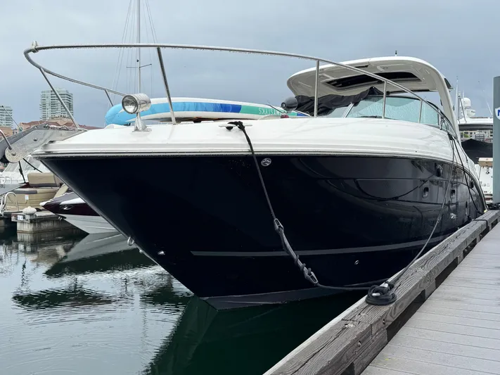 Andiamo Yacht Photos Pics 2016 Sea Ray 350 Sundancer docked at marina, sleek black hull, modern design.
