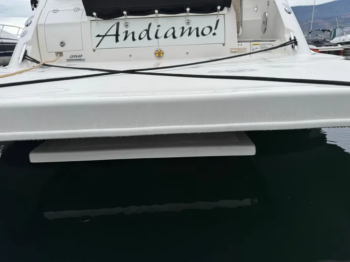 Andiamo Yacht Photos Pics 2016 Sea Ray 350 Sundancer boat stern with "Andiamo!" name, docked in calm water.