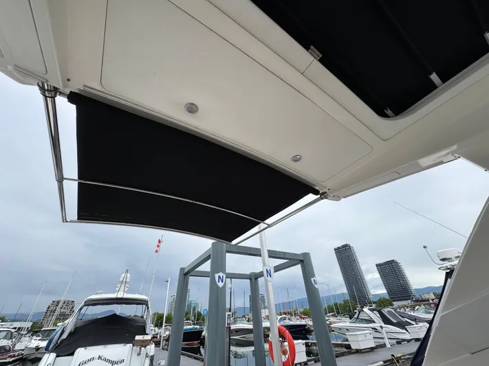 Andiamo Yacht Photos Pics 2016 Sea Ray 350 Sundancer at marina, view of retractable canopy and nearby boats.