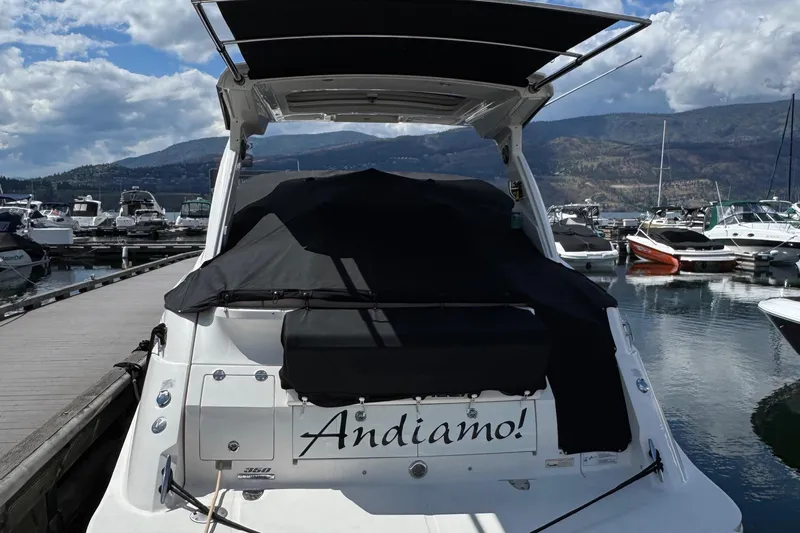 Andiamo Yacht Photos Pics Sea Ray 350 Sundancer 2016 docked, covered, with "Andiamo!" on the stern.