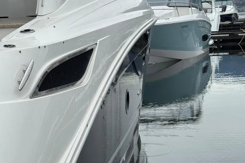Andiamo Yacht Photos Pics 2016 Sea Ray 350 Sundancer docked, sleek design, reflecting on calm water.