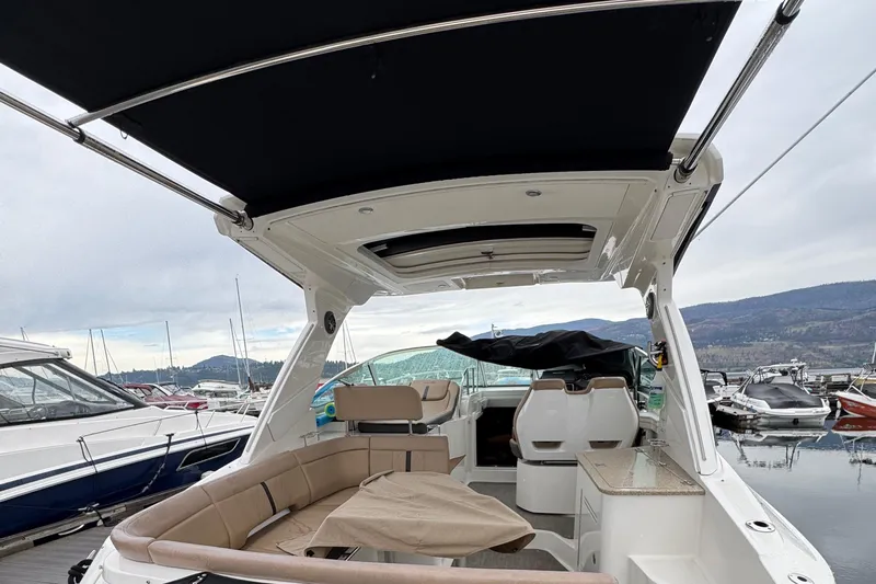 Andiamo Yacht Photos Pics 2016 Sea Ray 350 Sundancer boat with spacious seating and canopy at a marina.