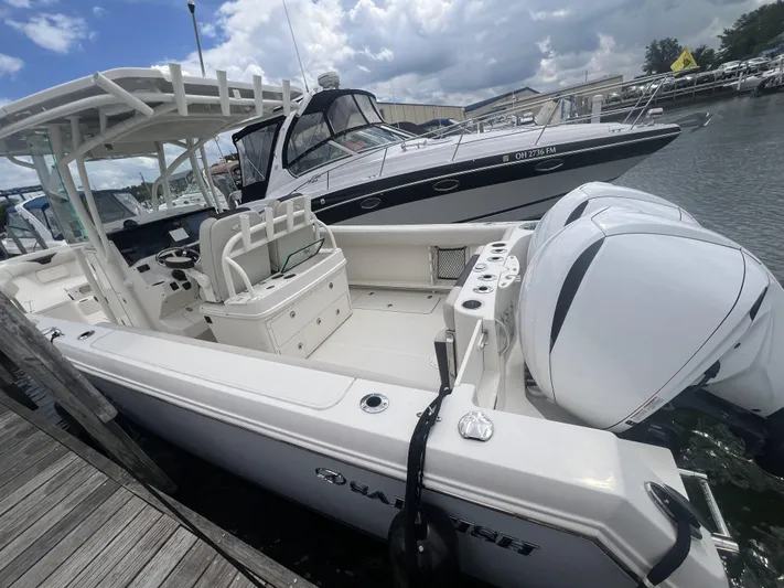  Yacht Photos Pics 2022 Sailfish 290cc boat docked, featuring dual outboard engines and spacious seating.