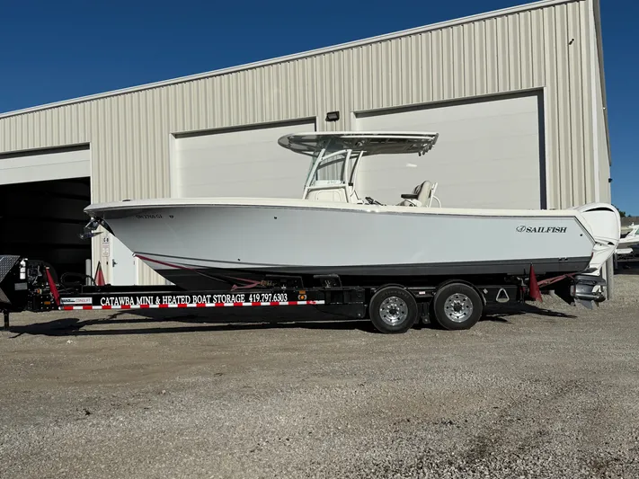  Yacht Photos Pics 2022 Sailfish 290cc boat on trailer outside storage facility.
