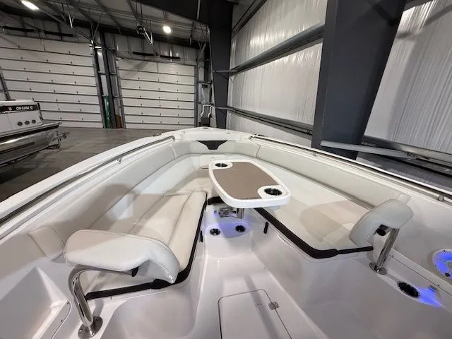  Yacht Photos Pics 2022 Sailfish 290cc boat interior with seating and table in a spacious garage.