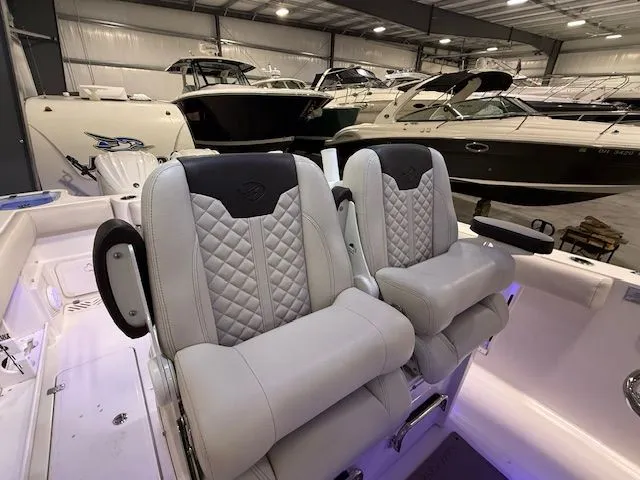  Yacht Photos Pics 2022 Sailfish 290cc boat interior with luxurious seating in a showroom.