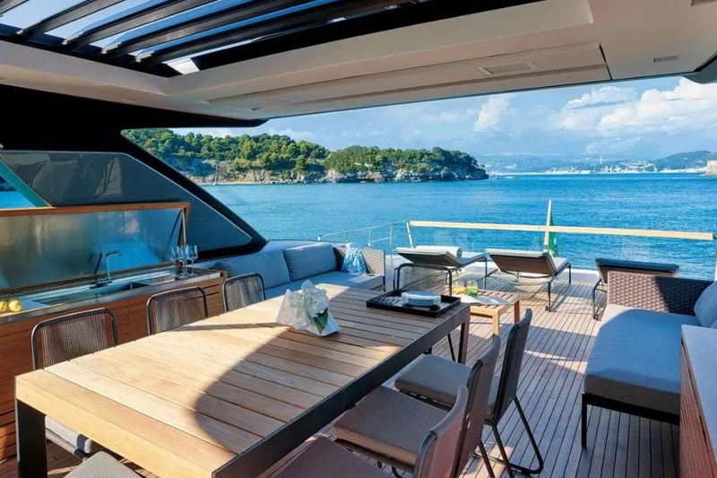  Yacht Photos Pics Luxurious 2022 Sanlorenzo SL86 yacht deck with dining area and ocean view.
