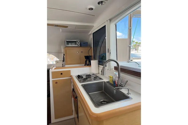 Apres-sea Yacht Photos Pics Interior of 2012 Lagoon 380 S2 yacht kitchen with sink, stove, and window view.