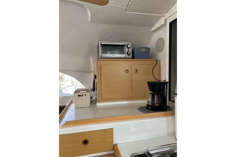 Apres-sea Yacht Photos Pics Interior of 2012 Lagoon 380 S2 yacht kitchen with appliances and wooden cabinetry.