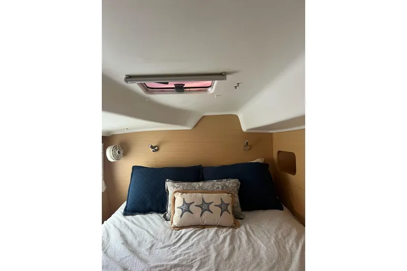 Apres-sea Yacht Photos Pics Cozy cabin interior of 2012 Lagoon 380 S2 with nautical-themed bedding.