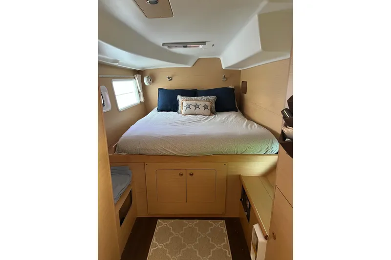 Apres-sea Yacht Photos Pics Cozy cabin interior of 2012 Lagoon 380 S2 catamaran with comfortable bedding and natural light.