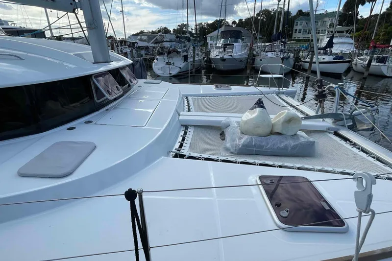 Apres-sea Yacht Photos Pics Lagoon 380 S2 catamaran, 2012 model, docked in a marina with other boats.