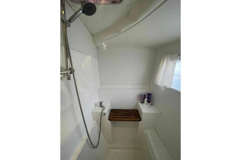 Apres-sea Yacht Photos Pics Bathroom interior of 2012 Lagoon 380 S2 yacht with shower and wooden seat.