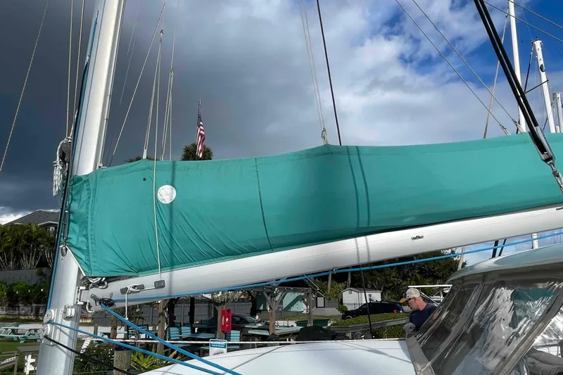 Apres-sea Yacht Photos Pics 2012 Lagoon 380 S2 sailboat with teal sail cover, docked under cloudy sky.