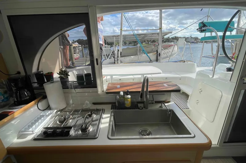 Apres-sea Yacht Photos Pics Interior view of 2012 Lagoon 380 S2 yacht kitchen with sink and stove.