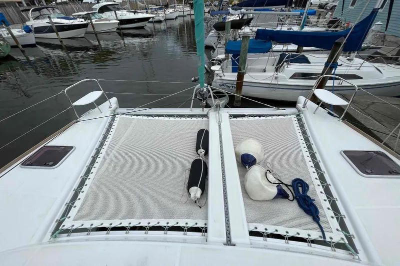Apres-sea Yacht Photos Pics 2012 Lagoon 380 S2 catamaran docked, featuring netting and marine equipment on deck.