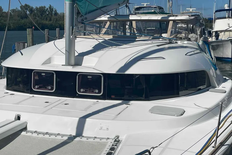 Apres-sea Yacht Photos Pics 2012 Lagoon 380 S2 catamaran docked at marina, featuring sleek design and spacious deck.
