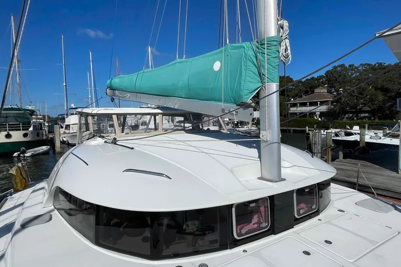 Apres-sea Yacht Photos Pics 2012 Lagoon 380 S2 catamaran docked at marina, featuring turquoise sail cover.