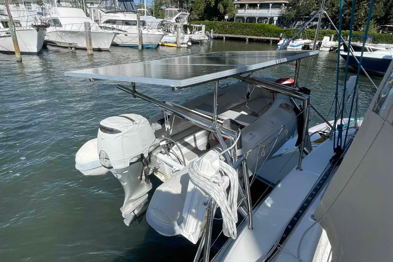 Apres-sea Yacht Photos Pics Catamaran Lagoon 380 S2 (2012) with solar panel and dinghy at marina.