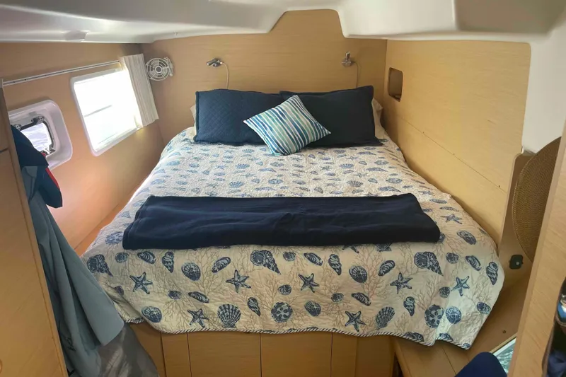 Apres-sea Yacht Photos Pics Cozy cabin interior of 2012 Lagoon 380 S2 with nautical-themed bedding.