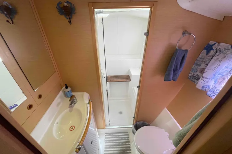 Apres-sea Yacht Photos Pics Compact bathroom in 2012 Lagoon 380 S2 yacht with shower, sink, and toilet.