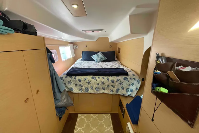 Apres-sea Yacht Photos Pics Cozy cabin interior of 2012 Lagoon 380 S2 catamaran with bed and storage.