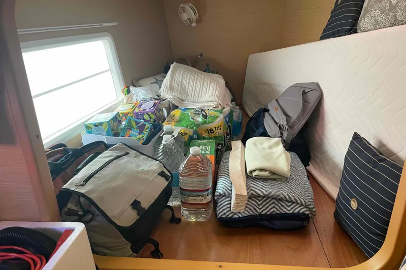 Apres-sea Yacht Photos Pics Interior of 2012 Lagoon 380 S2 yacht with supplies and bedding neatly arranged.