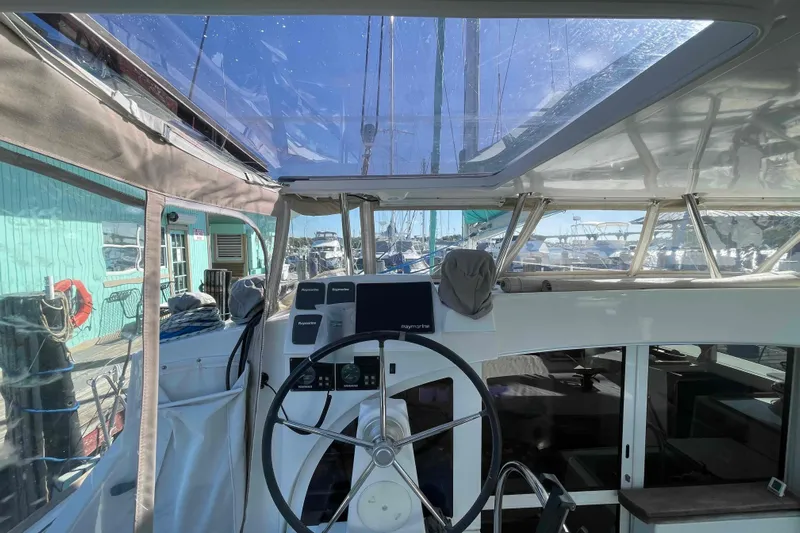 Apres-sea Yacht Photos Pics Cockpit view of 2012 Lagoon 380 S2 catamaran with steering wheel and navigation equipment.