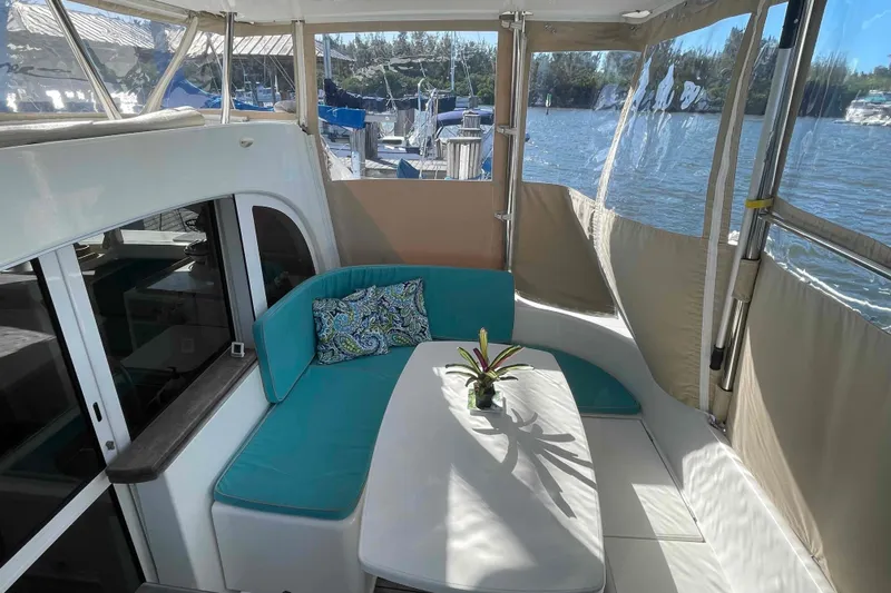Apres-sea Yacht Photos Pics Cozy seating area on 2012 Lagoon 380 S2 catamaran with scenic water view.