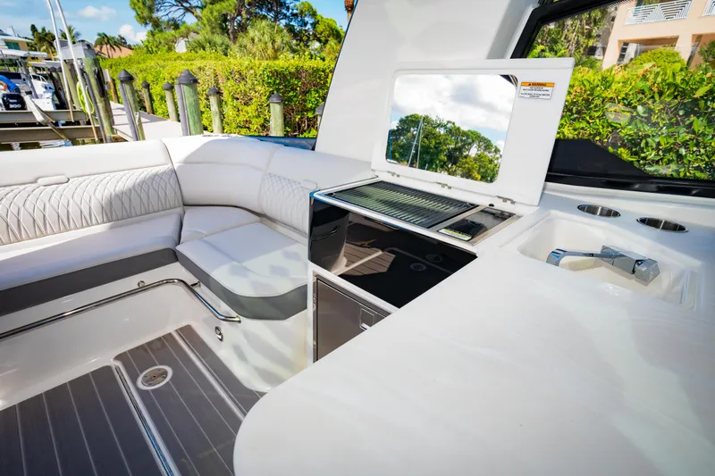 Yacht Photos Pics 2023 Sea Ray Sundancer 370 OB yacht interior with seating and kitchenette.