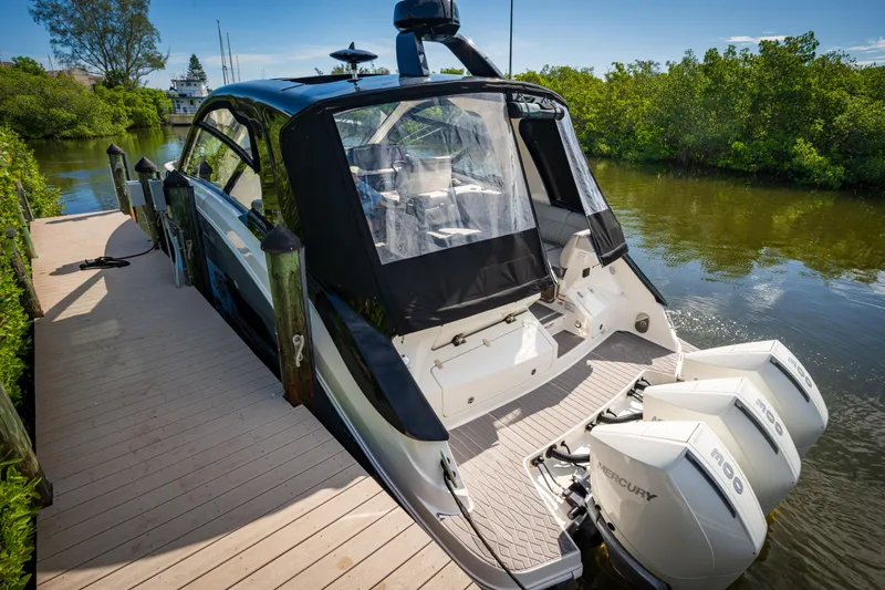  Yacht Photos Pics 2023 Sea Ray Sundancer 370 OB docked, rear view with twin Mercury outboard engines.