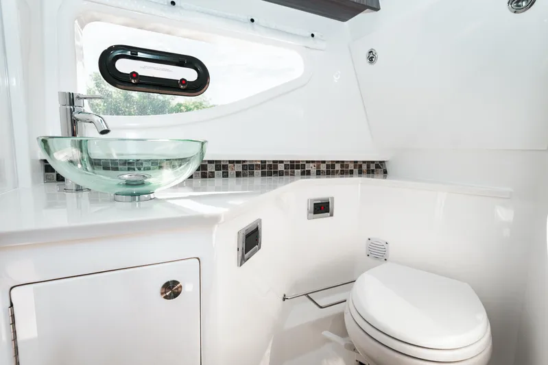 Yacht Photos Pics Modern bathroom in 2023 Sea Ray Sundancer 370 OB yacht with glass sink and mosaic backsplash.