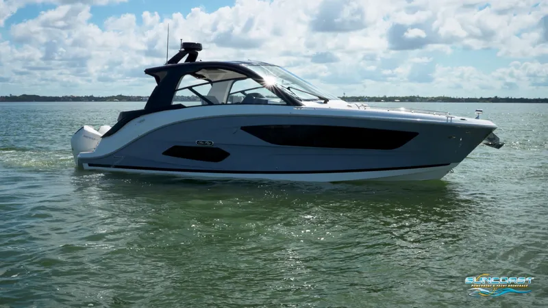  Yacht Photos Pics 2023 Sea Ray Sundancer 370 OB cruising on calm waters under a partly cloudy sky.