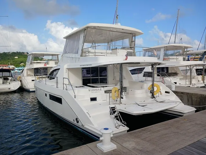 Whimsea II Yacht Photos Pics 2018 Leopard 51 Powercat yacht docked at marina under blue sky.