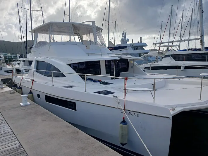 Whimsea II Yacht Photos Pics 2018 Leopard 51 Powercat yacht docked at marina, surrounded by other boats.