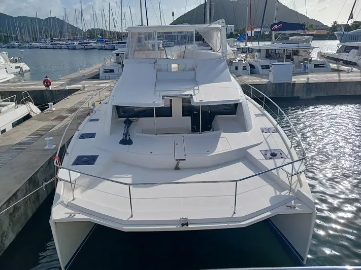 Whimsea II Yacht Photos Pics 2018 Leopard 51 Powercat yacht docked in marina, surrounded by sailboats.