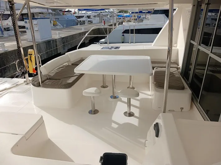 Whimsea II Yacht Photos Pics Leopard 51 Powercat 2018 yacht with outdoor seating and table at marina.