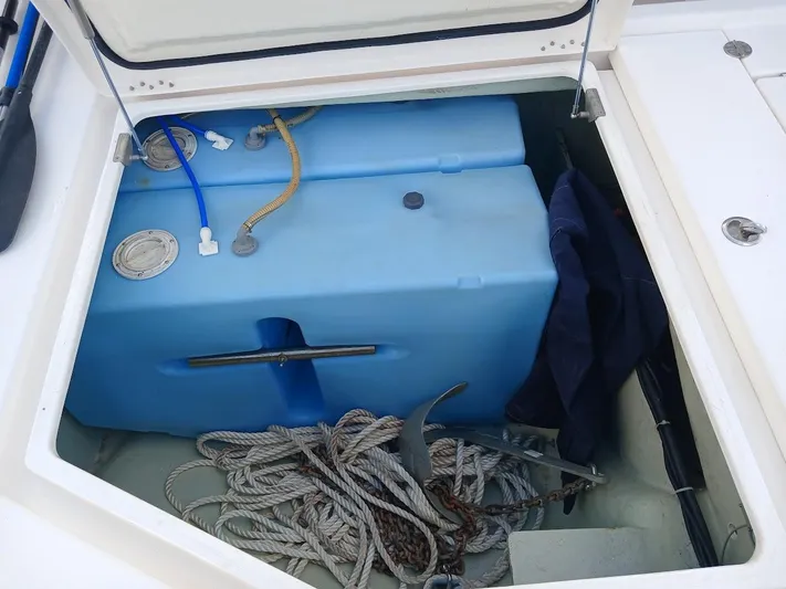 Whimsea II Yacht Photos Pics Storage compartment of 2018 Leopard 51 Powercat with blue water tank and ropes.